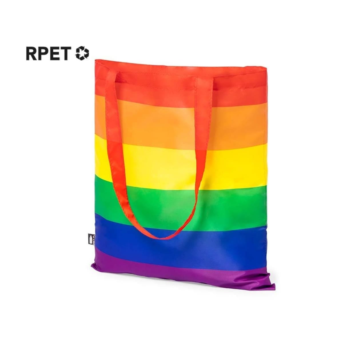 A reusable tote bag with rainbow stripes in shades of red, orange, yellow, green, blue, and purple. It has handles in red and a small black label on the side. The top left corner features a recycling symbol with the text RPET.
