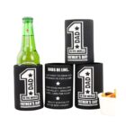 Four black beverage holders with 1 Dad in the World Fathers Day printed on them. Three holders have humorous dad quotes. A green beer bottle is in one holder, and a small white dish with mixed snacks is beside them.
