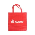 A red tote bag with two handles, featuring a white triangle logo and the word AVERY printed prominently in the center.