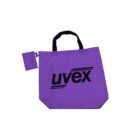 A purple tote bag with black handles and the word uvex printed in black on the front. A small matching pouch is attached to the bag by a zipper.