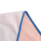 Close-up of a fabric with two sections: one white and the other light pink. They are bordered by a blue seam that creates a diagonal line across the image. The stitching detail is visible along the blue border.