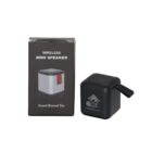 A small black wireless mini speaker with a luminous logo is placed next to its packaging box. The box is black and gray with text that reads WIRELESS MINI SPEAKER and Sound Beyond Size.