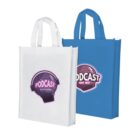 Two tote bags are displayed: one white and one blue. Each bag has a graphic of a microphone surrounded by pink headphones with the text Podcast on Air in a circular pink and purple design.