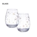 Two clear stemless glasses with delicate snowflake patterns in silver and gold. They stand side by side against a plain white background. The word GLASS is written in the top left corner.