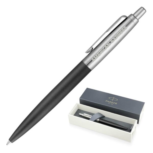 A sleek black and silver pen with the words American Express on the clip. It is shown next to an open box labeled Parker, which contains the same pen nestled inside a cream-colored interior.