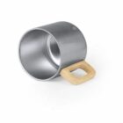 A silver metallic cup with a square wooden handle lies on its side against a white background. The interior and rim of the cup are visible.