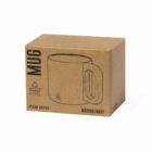 A cardboard box with the word MUG printed on it, featuring a simple line drawing of a mug. Text indicates Recycled Stainless Steel, item number 20703, and color Marino/Navy.