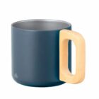 A dark blue mug with a large, light wooden handle. The mug has a minimalist design and smooth surface. The interior has a metallic finish, contrasting with the matte exterior.