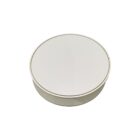 A simple, round, white container with a smooth, flat lid is shown against a plain white background.