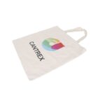 A cream-colored tote bag with the text CANTREX and a colorful geometric design featuring an abstract shape in green, blue, and red. The bag is lying flat on a white surface.
