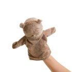 A hand is inside a light brown teddy bear hand puppet, making it appear animated. The plush puppet has round ears and small stitched details on a white background.