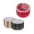 Three portable Bluetooth speakers with metallic finishes are shown. One is red with a unique pattern, the second is black, and the third is gold. They all have silver mesh tops and button controls at the base.