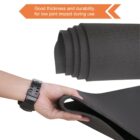 A person wearing a black watch holds a black rolled-up exercise mat, showing its thickness. An arrow points to the mat with text reading, Good thickness and durability for low joint impact during use.