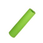 A rolled-up green yoga mat is standing upright against a plain white background.