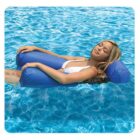 A person relaxing on a blue inflatable pool float, drifting on crystal clear water. The person is wearing a white swimsuit and has their eyes closed, appearing calm and content. The sun casts gentle reflections on the water.