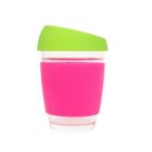 A clear reusable cup with a pink sleeve and a green lid. The cup is isolated on a white background.