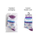 Two pairs of socks with similar blue and purple patterns. The left pair is in a clear plastic bag labeled Standard packaging, and the right pair has a Custom header card with a hang tag and the brand name akademiks.