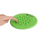 A hand pressing a green pop-it toy with circular bubbles on a flat surface. The pop-it toy is circular, and the hand is pushing down one of the bubbles. The words Chestnut Dental are printed on the toy.