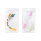 Two sets of colorful LEGO-style charging cables in clear plastic packaging. The left pack contains red, blue, green, and yellow connectors. The right pack has pink, white, yellow, and green connectors.