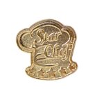 A gold pin featuring a stylized chefs hat with the words Star Chef written across it. Below the text, five gold stars are arranged in a row, adding to the designs emphasis on culinary excellence.