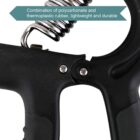 Close-up of a hand grip strengthener with a black handle. A metal spring is partially visible at the top. A label reads: Combination of polycarbonate and thermoplastic rubber, lightweight and durable.