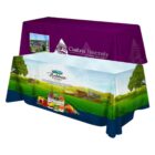 Two fabric table covers: one purple with Cambria University logo and another with a farm scene and Bolthouse Farms logo, showcasing produce.