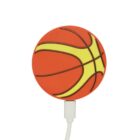 A round, flat portable charger designed to look like a basketball. It features orange and yellow colors with black contour lines. A charging cable is connected at the bottom.