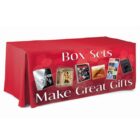 A table covered with a red cloth displays various box sets. The text Box Sets Make Great Gifts is printed across the front, with images of different box sets between the words.