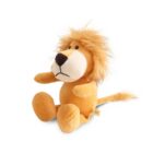 A plush lion toy sits upright. It has a golden-yellow body, an orange mane, and a long tail. The lions face features a large nose and round eyes. The toy appears soft and cuddly.