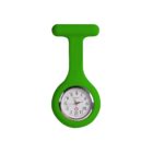 A round analog watch with a white face, black numerals, and black hands is encased in a bright green silicone holder resembling a pin shape. The holder has a loop at the top for attachment. The watch reads 10:09.