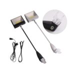 Two LED display lights with adjustable necks, one in black and one in silver, are shown. Each light has a clear clip at the end for attachment. Two power cords are also included. A close-up inlay shows the clip detail.