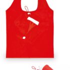 A red reusable shopping bag designed to look like a Santa hat. It features a white trim and a pom-pom at the tip. The bag can be folded and secured with an attached red loop for easy storage.