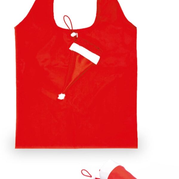 A red reusable shopping bag folds into a small cone resembling a Santa hat, shown both folded and unfolded. The bags main body is bright red with handles, and the folded hat portion includes a white trim and pom-pom.