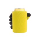 A can of Crystal Spring Peach Tea is wrapped in a bright yellow koozie with black gloves holding it. The background is plain white, highlighting the contrasting colors of the koozie and gloves.