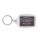 A rectangular keychain with a black and white label reading Campbells Realty and Family Owned Since 1970. The keyring is attached to the top left corner of the keychain.