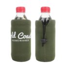 Two green neoprene bottle sleeves with red-capped bottles inside. The sleeves feature white text reading Gold Coast Homewares and have a pull-cord closure on one side for a snug fit.