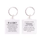 A keychain with two sides. One side has “R U OK?” and details for registering. The other lists emergency contacts under “PINKENBA,” with various emergency numbers and services.