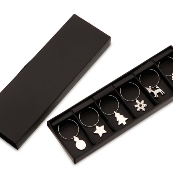 Set of six silver wine glass charms in a black box, featuring festive shapes: a bauble, star, Christmas tree, snowflake, reindeer, and stocking.