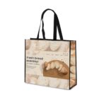 Tote bag featuring a bread-themed design. The main image shows slices of bread with the text Fresh bread everyday! with organic ingredients along with website navigation elements like Home, About Us, Shop, Services, Blog, and Contact.