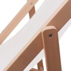 Close-up of a wooden deck chair frame with a white fabric seat.