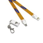 Orange lanyard with blue logos, featuring USB and charging ports at each end. A white plastic cap with a metal keychain clip is attached to the lanyard, providing protection for the connectors.