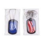 Two dog tags in packaging. The left tag is blue with Mighty Milers Run For Life printed on it, while the right tag features an American flag design. Both tags are attached to silver ball chains.