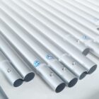 Rows of silver metal tubes with varying lengths, each with a small hole near the end and blue numbered labels. The tubes are neatly arranged on a light surface.