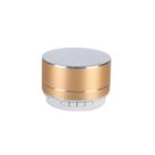 A small, gold cylindrical Bluetooth speaker with a silver mesh top and white controls on the base.