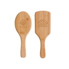 Two wooden hairbrushes with different shapes. The left one is oval with YOURTEXT and a geometric design engraved. The right one is rectangular with rounded edges, featuring the word miracle and a stylized logo. Both have smooth handles.