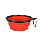 Collapsible red silicone pet bowl with a black rim and a carabiner attached for easy carrying.