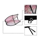 Collapsible pink laundry basket with a unicorn pattern, shown in a disassembled view with focus on details: the logo, a metal grommet, and black fabric ties. The basket is supported by a black frame.