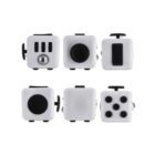 A fidget cube with various tactile controls, including three switches, a metallic ball, a joystick, buttons, and dials, is displayed in six different angles to show all its features. The cube is primarily white with black accents.