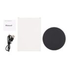 A wireless charging pad set with a round black pad, a white manual booklet, and a USB charging cable, displayed next to a white rectangular box.