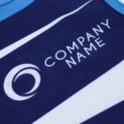 A close-up of a sports jersey featuring a blue and white design. The jersey displays a circular logo and the text Company Name in white letters.